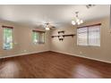 Bright living room featuring wood floors, neutral walls, shelving and plentiful windows at 13722 N 150Th Ln, Surprise, AZ 85379