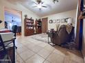 Comfortable living room featuring tile floors, neutral paint, ceiling fan, and an elegant rug at 14211 N 149Th Dr, Surprise, AZ 85379