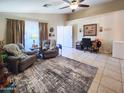 Bright living room showcasing tile floors, neutral walls, and plush seating for relaxation at 14211 N 149Th Dr, Surprise, AZ 85379
