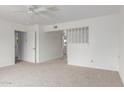 Bright living room with neutral carpet, ceiling fan and access to other rooms at 1515 N Saguaro Dr, Tempe, AZ 85288