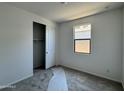 This bedroom has a closet, a window for natural light, and neutral carpeting at 15785 W Beryl Ave, Waddell, AZ 85355