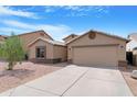 Attractive home featuring a well-kept front yard, desert landscaping, and attached two-car garage at 1623 E Leaf Rd, San Tan Valley, AZ 85140