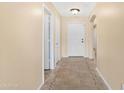 Hallway boasts neutral walls and tiled flooring accented by decorative tile border at 1623 E Leaf Rd, San Tan Valley, AZ 85140