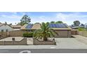 Charming home with solar panels, a two-car garage, desert landscaping, and privacy wall with mature plants at 17244 N 29Th Ave, Phoenix, AZ 85053
