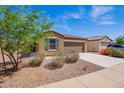 Well maintained single-story home with low maintenance landscaping, blue sky and flowering bushes at 1762 E Elegante Dr, Casa Grande, AZ 85122