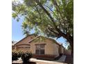 Charming home featuring desert landscaping, a tile roof, and mature trees providing shade at 1827 E Carla Vista Dr, Gilbert, AZ 85295