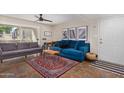 Bright living room featuring two couches, stylish decor, and access to a patio at 1880 E Morten Ave # 125, Phoenix, AZ 85020