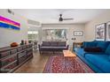 Inviting living room with two sofas, a unique coffee table, and lots of natural light at 1880 E Morten Ave # 125, Phoenix, AZ 85020