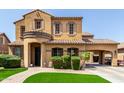 Charming two-story home with tile roof, arched entryway, and lush green landscaping at 20366 E Via De Colina --, Queen Creek, AZ 85142