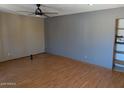 Spacious living room area featuring hardwood flooring and a ceiling fan at 2179 E Palmcroft Dr, Tempe, AZ 85282