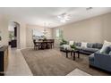 Open concept living room featuring neutral colors, a ceiling fan, and a dining area at 2507 E Eleana Ln, Gilbert, AZ 85298