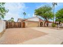 Charming single-story home with manicured landscaping, a two-car garage, and a secure side yard at 3138 W Danbury Dr, Phoenix, AZ 85053