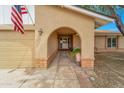 Inviting front porch with decorative brick accents and an arched entryway leading to the front door at 3138 W Danbury Dr, Phoenix, AZ 85053