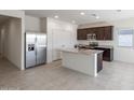 Spacious kitchen with a center island, stainless steel appliances, and plenty of natural light at 42900 W Palo Amarillo Rd, Maricopa, AZ 85138
