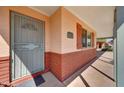 Covered front porch with red brick accents, security door and brick mailbox at 4418 W Palo Verde Ave, Glendale, AZ 85302