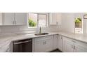 Bright modern kitchen features stainless steel appliances and white cabinetry at 4526 E Bannock St, Phoenix, AZ 85044