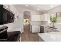 Kitchen features a new stainless dishwasher, microwave, and white cabinets with stone countertops at 4526 E Bannock St, Phoenix, AZ 85044