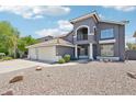 Attractive two-story home featuring a spacious three-car garage and desert landscaping at 553 E Baylor Ln, Gilbert, AZ 85296