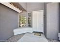 Welcoming front entry featuring a white door with sidelight and decorative window at 553 E Baylor Ln, Gilbert, AZ 85296