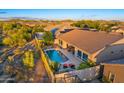 Aerial view of a private backyard with pool, privacy fence, patio furniture, and well-kept landscaping at 5626 E Sleepy Ranch Rd, Cave Creek, AZ 85331