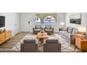 Bright living room with modern furniture, light wood floors and a large window at 5918 S Parkside Dr, Tempe, AZ 85283