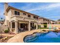 Inviting backyard features a sparkling pool, covered patio, and lush landscaping, perfect for outdoor entertaining at 5993 W Topeka Dr, Glendale, AZ 85308