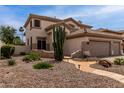Charming home with desert landscaping featuring mature cacti, stone pathway, and desert plants at 5993 W Topeka Dr, Glendale, AZ 85308