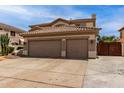 Exterior view of a two-story home featuring a three-car garage and well-maintained landscaping at 5993 W Topeka Dr, Glendale, AZ 85308