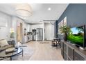 Open-concept living space with tiled floors, stainless appliances, and access to multiple entrances at 6338 W Raymond St, Phoenix, AZ 85043