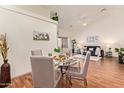 Cozy dining area with a round glass table and views into the spacious living room at 64 N 63Rd St # 55, Mesa, AZ 85205