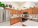Well-lit kitchen with stainless steel appliances and beautiful wood cabinets at 64 N 63Rd St # 55, Mesa, AZ 85205