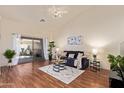 Bright living room with hardwood floors, sliding glass doors, and a ceiling fan at 64 N 63Rd St # 55, Mesa, AZ 85205