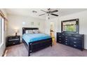 Bright main bedroom featuring a large bed, dark wood furnishings, and access to an ensuite bathroom at 7501 S 14Th St, Phoenix, AZ 85042