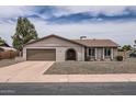 Charming single-story home featuring a well-maintained front yard and attached garage with a wide driveway at 828 E Le Marche Ave, Phoenix, AZ 85022