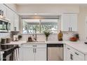 Well-lit kitchen with quartz countertops, stainless steel appliances, and a view through the window at 828 E Le Marche Ave, Phoenix, AZ 85022