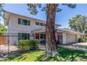 Two-story home features a red door, gray garage door, a black metal fence and a manicured lawn at 8464 N 7Th Ave, Phoenix, AZ 85021