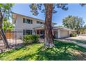 Two-story home features a red door, gray garage door, a black metal fence and a manicured lawn at 8464 N 7Th Ave, Phoenix, AZ 85021