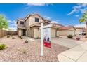 Attractive home featuring desert landscaping, a two-car garage, and a for sale sign at 864 S 223Rd Ln, Buckeye, AZ 85326
