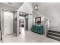 Inviting foyer with decorative console table, tiled floors, and staircase to the upper level at 868 W Desert Glen Dr, San Tan Valley, AZ 85143