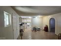 Bright and airy living space adjacent to the kitchen with tiled floors at 10408 W Devonshire Ave, Phoenix, AZ 85037