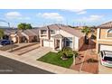 Aerial view of a well-maintained home featuring lush green grass, a tile roof and mature landscaping at 11056 W Lane Ave, Glendale, AZ 85307