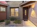 Inviting front entrance showcasing a secure iron door, tasteful lighting, and low-maintenance desert landscaping at 11400 E Helm Dr, Scottsdale, AZ 85255