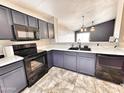 Open kitchen featuring black appliances, dark gray cabinets, tile floor, and bright white countertops at 1339 W Mesquite Ave, Apache Junction, AZ 85120