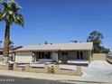 Single-story home with a beige exterior, well-maintained landscaping, and a spacious driveway at 13801 N 37Th Dr, Phoenix, AZ 85053