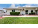Charming single-story home with a well-manicured lawn and inviting front entrance at 14224 N Newcastle Dr, Sun City, AZ 85351