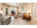 Comfortable living room with plush seating, a ceiling fan, and a sliding glass door at 14950 W Mountain View Blvd # 5306, Surprise, AZ 85374