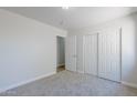 Bedroom featuring fresh paint, carpet, a closet, and a doorway leading to another room at 16159 W Maui Ln, Surprise, AZ 85379