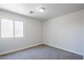 Comfortable carpeted bedroom featuring a window, a fresh paint job, and ample space at 16159 W Maui Ln, Surprise, AZ 85379