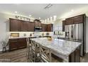 Spacious kitchen boasts granite countertops, stainless steel appliances, and ample cabinet space at 16202 N 61St Ave, Glendale, AZ 85306