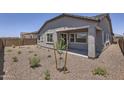 Beautiful backyard featuring desert landscaping and a covered patio, perfect for outdoor enjoyment at 17557 W Victory St, Goodyear, AZ 85338
